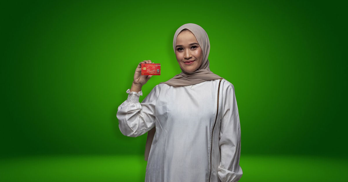 The copy of the smart car fuel card is in the hands of a young and happy veiled woman